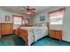 Bedroom with light blue walls and blue carpet and a dresser at 6421 Wilshire Dr, Tampa, FL 33615