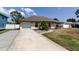 Charming single-Gathering home with attached garage, driveway, and inviting curb appeal at 6421 Wilshire Dr, Tampa, FL 33615
