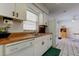 Bright kitchen featuring white cabinetry, wood countertops and tile floors at 6421 Wilshire Dr, Tampa, FL 33615