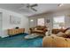 Comfortable living room with ceiling fan and natural light from bright windows at 6421 Wilshire Dr, Tampa, FL 33615