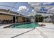 Refreshing screened-in pool area, perfect for relaxation and outdoor entertainment at 6421 Wilshire Dr, Tampa, FL 33615