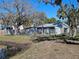 View of the yard with the house, seen from the water at 6903 11Th Ave E, Palmetto, FL 34221