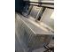 Exterior view of outdoor hot tub with corrugated metal base, set against house with double glass doors at 6903 11Th Ave E, Palmetto, FL 34221