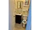 Compact bathroom featuring a vanity with a mirror, a toilet, and neutral-toned tiles and decor at 6903 11Th Ave E, Palmetto, FL 34221