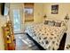 Cozy bedroom featuring a queen-sized bed with decorative pillows, a window with blinds, and wall decorations at 6903 11Th Ave E, Palmetto, FL 34221