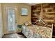 Cozy bedroom with wood accent wall, light grey flooring and a decorative bedside table at 6903 11Th Ave E, Palmetto, FL 34221
