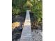 Picturesque wooden boardwalk surrounded by lush greenery, leading to the waterfront at 6903 11Th Ave E, Palmetto, FL 34221