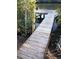 Wooden dock on the water with lush greenery, perfect for enjoying the waterfront at 6903 11Th Ave E, Palmetto, FL 34221
