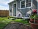 Inviting home exterior with artificial turf, complemented by decorative seating and vibrant potted plants at 6903 11Th Ave E, Palmetto, FL 34221