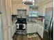 Bright kitchen features stainless steel appliances, granite countertops, and white cabinetry at 6903 11Th Ave E, Palmetto, FL 34221