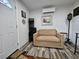 Living room with a beige couch, decorations and dark brown floors at 6903 11Th Ave E, Palmetto, FL 34221