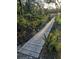 Wooden boardwalk winding through lush greenery offers a tranquil escape at 6903 11Th Ave E, Palmetto, FL 34221