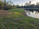 Beautiful pond with lush grassy shoreline, trees, and waterfront views for serene enjoyment at 6903 11Th Ave E, Palmetto, FL 34221