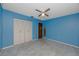 Large bedroom with closet and carpeted floors, offering ample space and comfort at 7020 Sonata Dr, Port Richey, FL 34668
