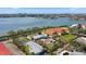 Aerial view of homes near water with city view in background at 7075 Sunset S Dr, South Pasadena, FL 33707