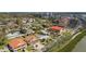Scenic aerial view of the waterfront neighborhood and water with distant city skyline at 7075 Sunset S Dr, South Pasadena, FL 33707
