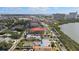 Aerial shot of a property located near commercial buildings, palm trees, and a lake at 7075 Sunset S Dr, South Pasadena, FL 33707