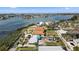 Aerial view of a waterfront home with lush greenery and stunning views of the surrounding bay area at 7075 Sunset S Dr, South Pasadena, FL 33707