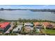 Stunning aerial view of waterfront homes with city skyline, dock and neighborhood amenities at 7075 Sunset S Dr, South Pasadena, FL 33707
