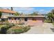 Full front view of the home and the front yard at 7075 Sunset S Dr, South Pasadena, FL 33707