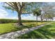 Well-maintained green space with mature trees and pedestrian walkway at 7075 Sunset S Dr, South Pasadena, FL 33707