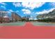 Outdoor tennis courts in a residential complex surrounded by trees and green space at 7075 Sunset S Dr, South Pasadena, FL 33707