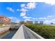 Scenic view of the pedestrian bridge over the water, with vegetation and city buildings at 7075 Sunset S Dr, South Pasadena, FL 33707