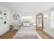 Bright bedroom with bed centered between mirrored sconces, natural light, and cozy decor at 708 53Rd N Ave, St Petersburg, FL 33703