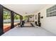 Covered front porch with black accent columns, chairs and a stylish rug at 708 53Rd N Ave, St Petersburg, FL 33703