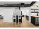 Modern kitchen with white cabinets, black island, and sleek bar stool seating at 708 53Rd N Ave, St Petersburg, FL 33703