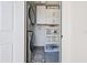 Laundry room featuring modern washer and dryer units, cabinets, and decorative accents at 708 53Rd N Ave, St Petersburg, FL 33703