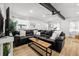 Open concept living room with wood flooring, black leather sofa and natural light at 708 53Rd N Ave, St Petersburg, FL 33703