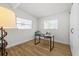 Bright office featuring wood floors, two windows, and a sleek black desk at 708 53Rd N Ave, St Petersburg, FL 33703