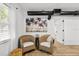 Cozy sitting area with rattan chairs, palm tree art, and bright natural lighting at 708 53Rd N Ave, St Petersburg, FL 33703