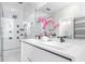 Modern bathroom features a double vanity with sleek fixtures, a large mirror, and a glass-enclosed shower at 7130 102Nd Ln, Seminole, FL 33772