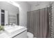 Modern bathroom features a stylish vanity, sleek faucet, and combined shower and tub with elegant design at 7130 102Nd Ln, Seminole, FL 33772