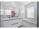 Bright bathroom boasts double vanity with sleek, modern finishes, plus a soaking tub and large window at 7130 102Nd Ln, Seminole, FL 33772