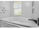 Luxurious soaking tub features jets, modern hardware, and is situated beside a window for natural light at 7130 102Nd Ln, Seminole, FL 33772