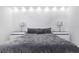 Modern bedroom with decorative textured wall paneling and two side tables at 7130 102Nd Ln, Seminole, FL 33772