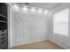 Chic bedroom with a textured accent wall, recessed lighting, and hardwood floors, bathed in natural light at 7130 102Nd Ln, Seminole, FL 33772