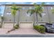 Exterior view of townhomes showcasing garages, manicured landscaping and private driveway parking at 7130 102Nd Ln, Seminole, FL 33772
