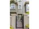 Townhouse front exterior showing gate entrance and neutral color scheme at 7130 102Nd Ln, Seminole, FL 33772