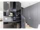 Modern kitchen with dark cabinetry, wine cooler, beverage center, and textured wall at 7130 102Nd Ln, Seminole, FL 33772