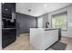 Bright kitchen with a center island featuring a sink and black fixtures at 7130 102Nd Ln, Seminole, FL 33772