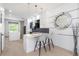 Modern kitchen with white cabinetry, island with seating, and stainless steel appliances at 7130 102Nd Ln, Seminole, FL 33772
