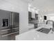 Modern kitchen featuring sleek white cabinets, stainless steel appliances, and a large center island at 7130 102Nd Ln, Seminole, FL 33772