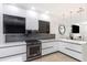 Modern kitchen with white cabinets, stainless steel appliances, and marble countertops at 7130 102Nd Ln, Seminole, FL 33772
