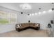 Cozy living room with brown sectional couch and textured wall paneling at 7130 102Nd Ln, Seminole, FL 33772