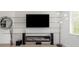 Living room featuring a modern fireplace, mounted television and accent wall at 7130 102Nd Ln, Seminole, FL 33772