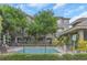 Inviting community pool surrounded by lush greenery, offering a relaxing retreat at 7130 102Nd Ln, Seminole, FL 33772